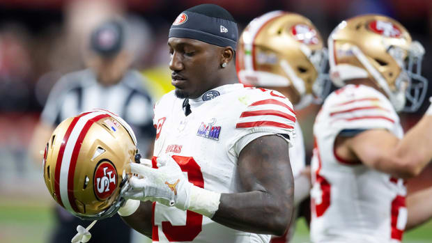 49ers wide receiver Deebo Samuel puts on his helmet.
